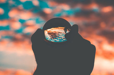 Portrait of silhouette person holding umbrella against sky during sunset