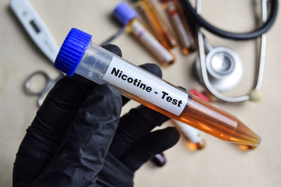 Midsection of man holding syringe