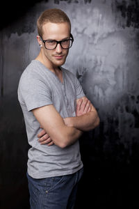 Portrait of young man wearing eyeglasses standing outdoors