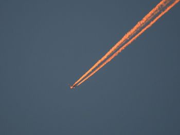 Low angle view of airplane flying against clear sky