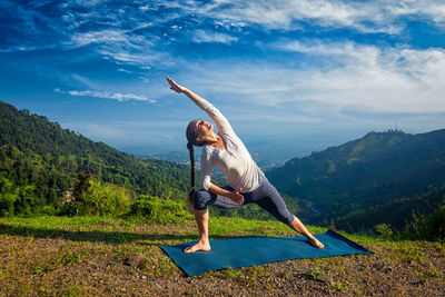 Rear view of woman standing on mountain