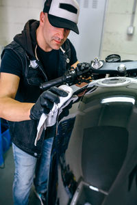 Mechanic with motorcycle at garage