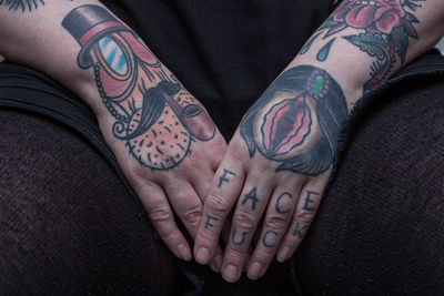 Midsection of woman with tattooed hands