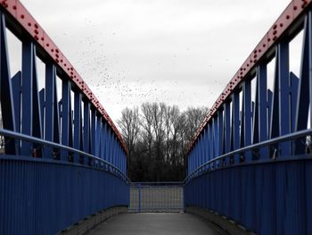 Bridge over footbridge against sky