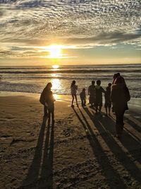 People on beach at sunset