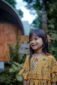 The smile of a little asian girl who just woke up and standing outdoor