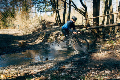 Man riding bicycle in forest