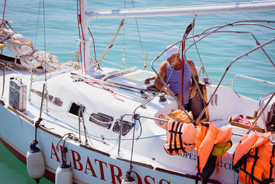 Close-up of boats moored in sea against sky