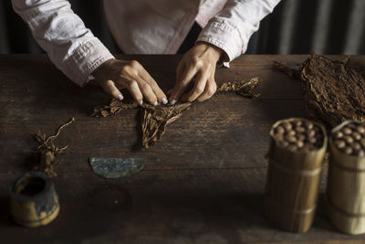 Midsection of woman working on tobacco factory