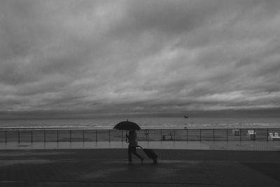 Full length of man on beach against sky