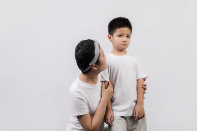 Boy standing against white background