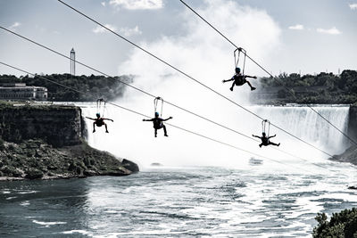 People in the sky against waterfalls