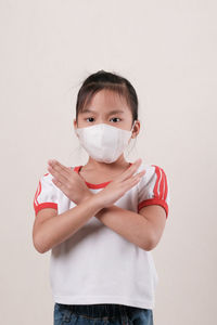 Portrait of girl standing against white background