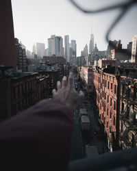 Man and cityscape against sky