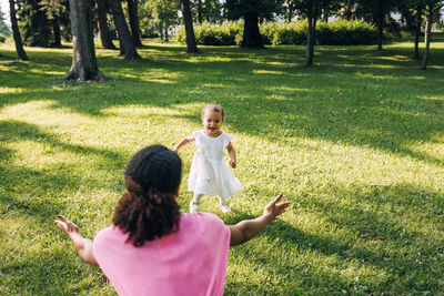 Rear view of a girl looking away on field