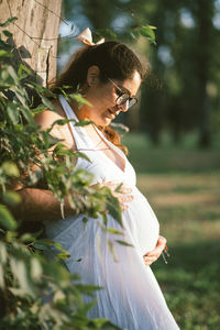 Side view of woman standing on field