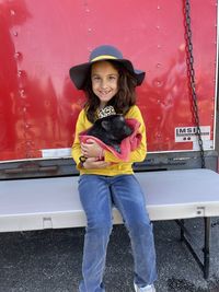 Hispanic girl at rodeo holding piglet