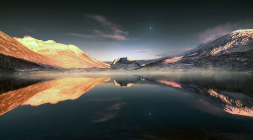 Scenic view of lake against sky during sunset