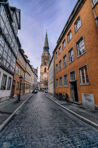 View of street amidst buildings in city