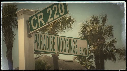 Low angle view of sign board against sky