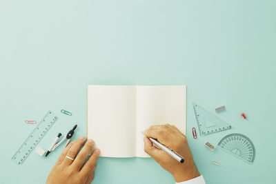 Hand holding paper against white background