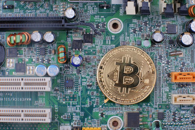 Directly above shot of bitcoin on circuit board