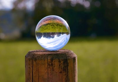 Close-up of crystal ball on wooden table