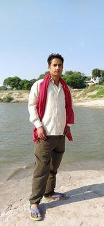 Portrait of young man standing on beach