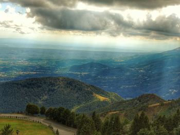 Scenic view of mountains against cloudy sky