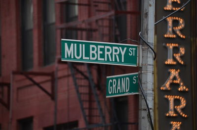 Low angle view of new york street sign against building