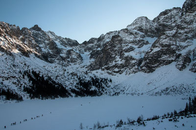 Scenic view of snowcapped mountains against clear sky