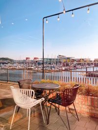 Empty chairs and tables at outdoor cafe