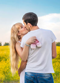 Couple kissing each other in field