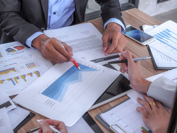 Low section of people working on table