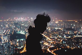 VIEW OF ILLUMINATED CITYSCAPE AT NIGHT