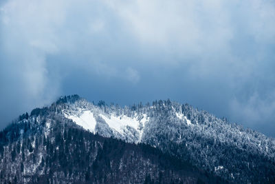 Low angle view of snowcapped mountain against sky