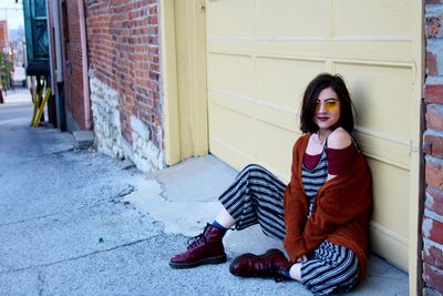 Portrait of young woman sitting outdoors