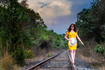 Full length of woman standing on railroad track