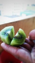 Close-up of cropped hand holding apple