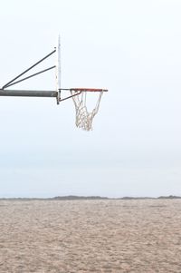 Low angle view of basketball hoop against clear sky