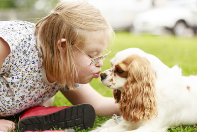 Girl kissing dog on nose