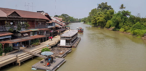 High angle view of houses by river against sky