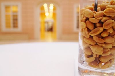 Close-up of peanuts in jar on table