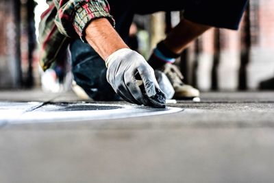 Low angle view of man drawing on street