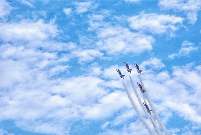 Low angle view of airshow against sky