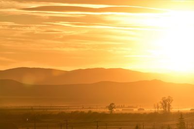 Scenic view of silhouette mountains against sky during sunset