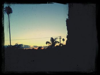 Silhouette of trees against sky at sunset