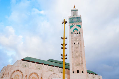 Low angle view of lighthouse against cloudy sky