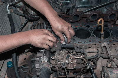 Midsection of man repairing car