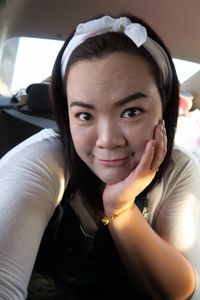 Close-up portrait of woman sitting in car